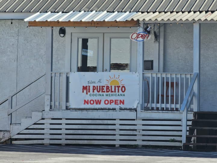 Mi Puebltio Cocina Mexicana now open sign on a white building