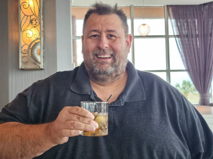 john holding an old fashioned cocktail 