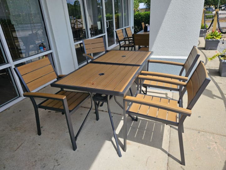 outdoor table and chairs next to the restaurant entrance