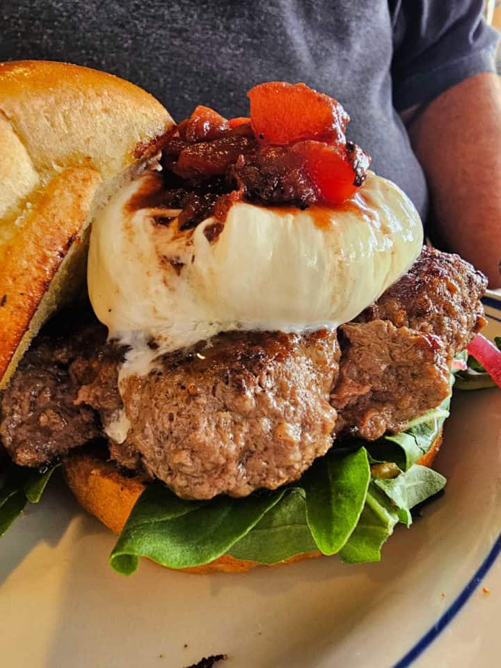 Wagyu burger with burarata cheese and lettuce and a brioche bun