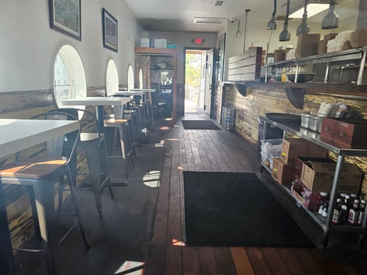 tall tables and chairs next to a serving counter in Avenue Pub