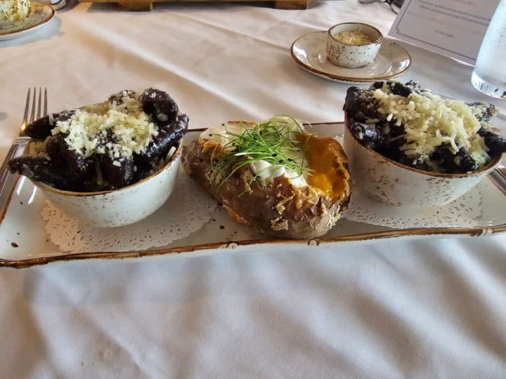 purple sweet potato gnocchi in two bowls next to a salt crusted baked potato