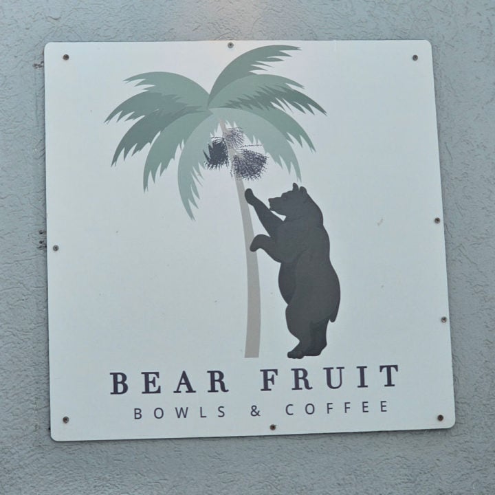 Bear Fruit Bowls and Coffee sign with bear reaching up to a palm tree