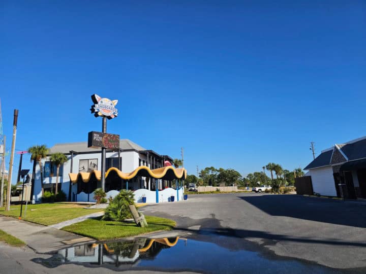 Longboards Restaurant sign over the building with paved parking lot