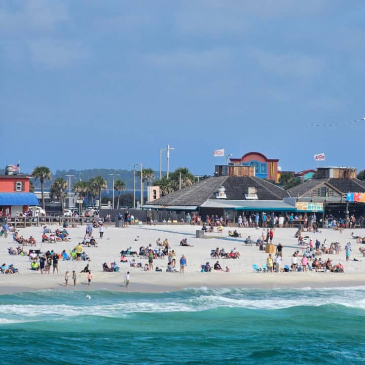 looking over the water to people on Casino Beach with restaurants in the background