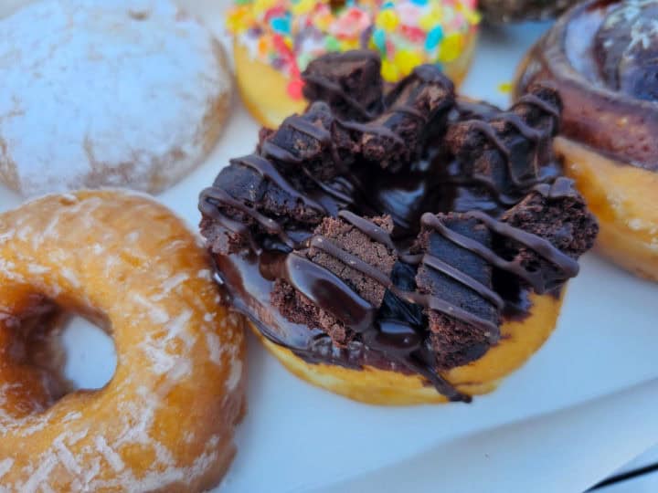 chocolate brownie piececs covered in chocolate on the top of a donut