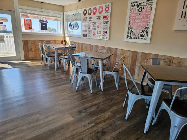 indoor tables and chains along a wall with donut art