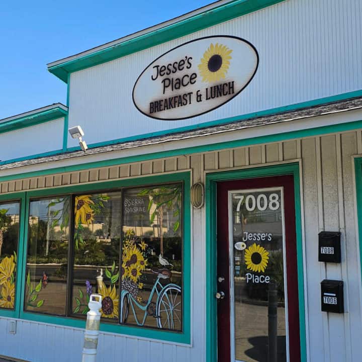 Jesse's Place breakfast and lunch sign over restaurant entrance, sunflowers painted on the windows