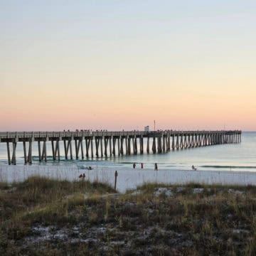 long pier over the water at sunset