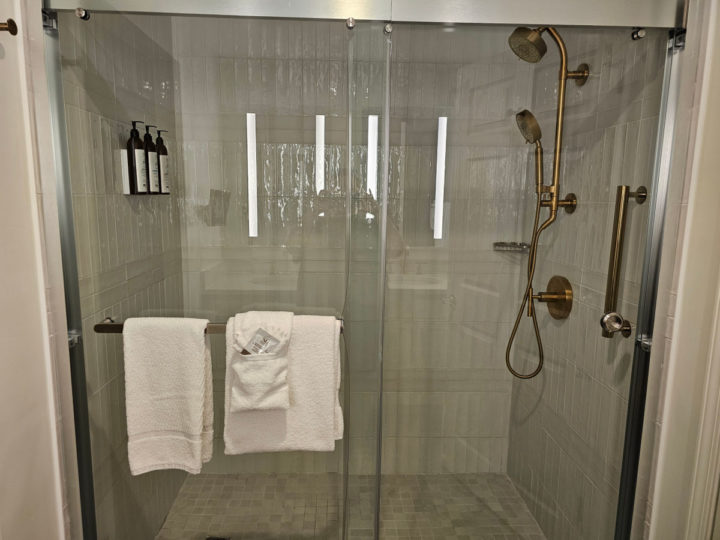 walk in glass masterbedroom shower with gold fixtures