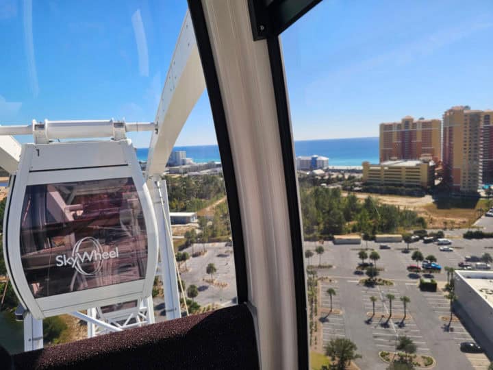 Looking out the window to a SkyWheel and the Gulf of Mexico in the distance