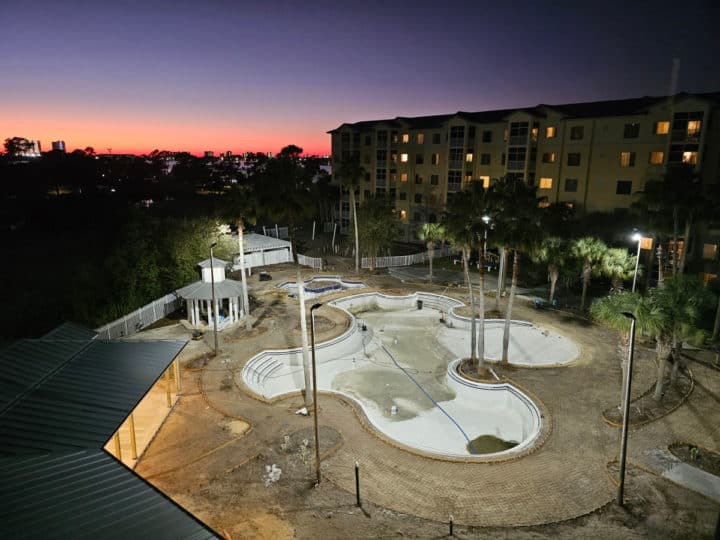 empty pool under construction with sunset in the background