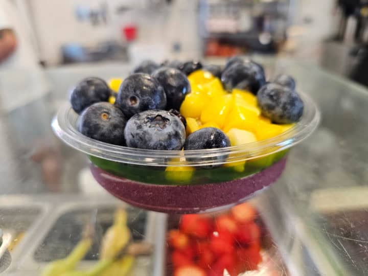 Acai bowl topped with blueberries and mango