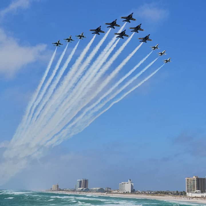 Blue Angels and Thunderbirds planes in a super delta formation over Pensacola Beach