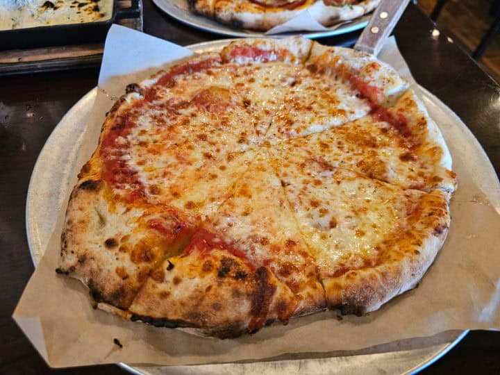 Cheese pizza on a parchment lined pan