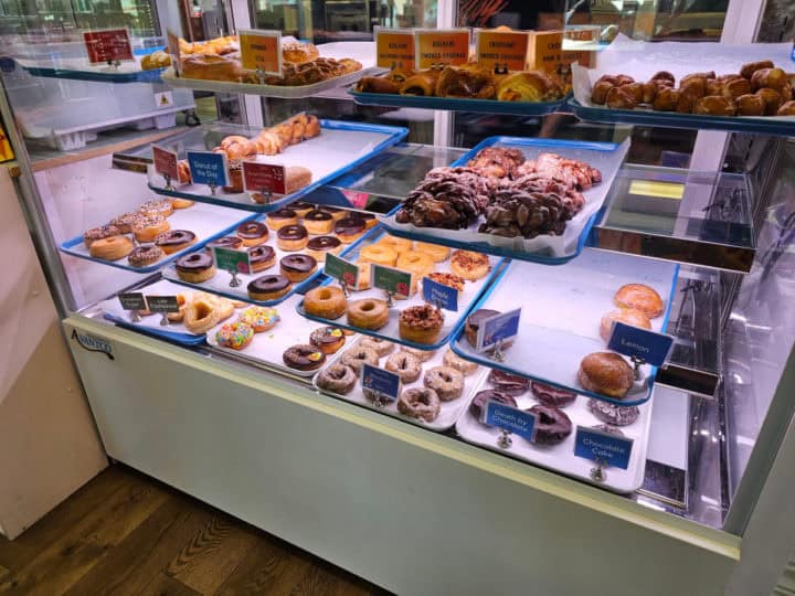 Donuts on trays in a bakery case