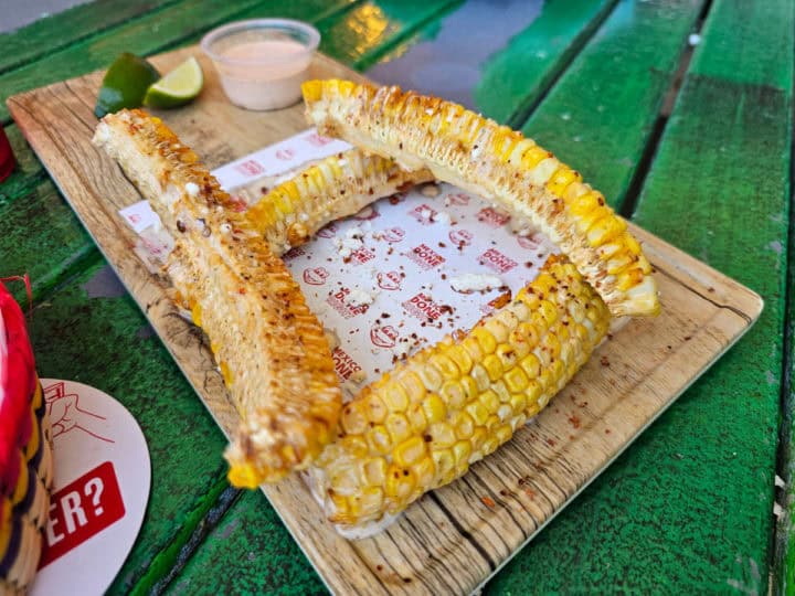 Corn ribs on a Senor Frogs paper lined wood board with dipping sauce