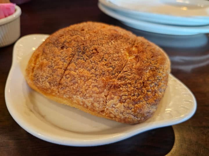 small loaf of fresh bread on a white plate