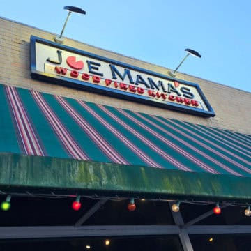 Joe Mama's Wood Fired Kitchen sign above a striped awning and windows