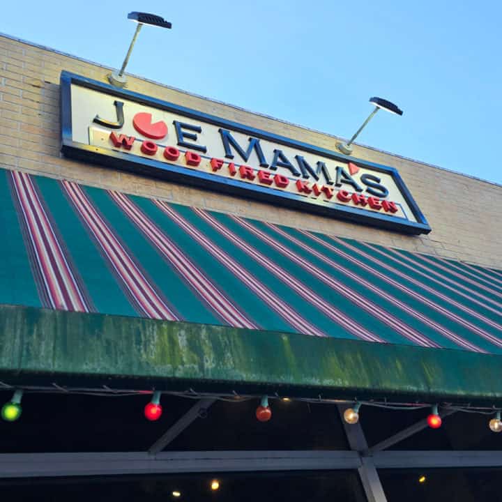 Joe Mama's Wood Fired Kitchen sign above a striped awning and windows