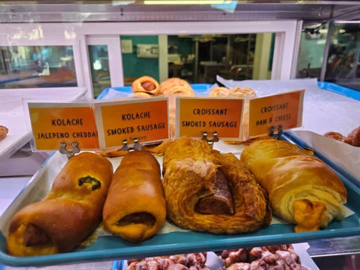 Kolaches on a tray in a bakery case