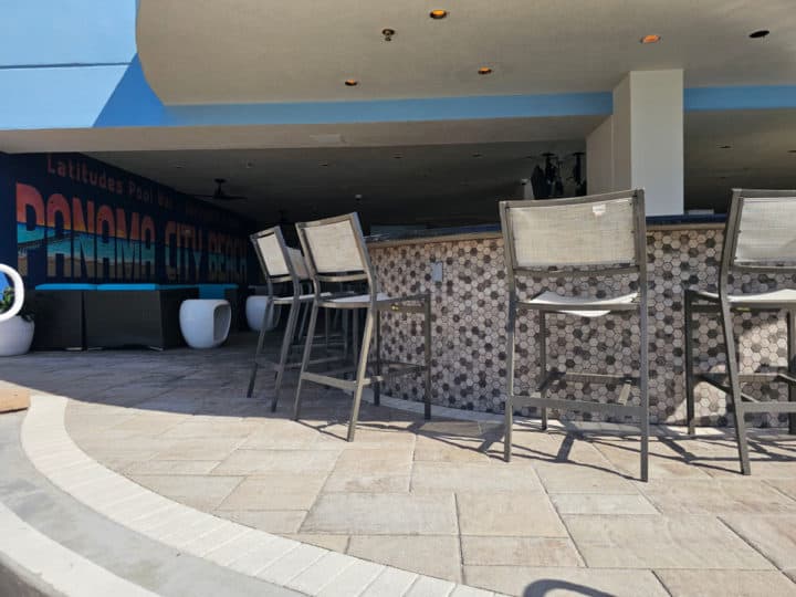 outdoor pool bar with Panama City Beach mural next to it