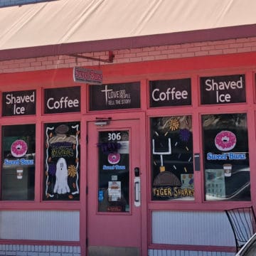 Pink entrance with Sweet Bunz sign, and donuts painted on the window