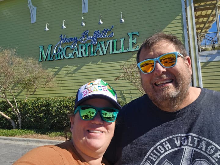 Tammilee and John standing by the Margaritaville sign