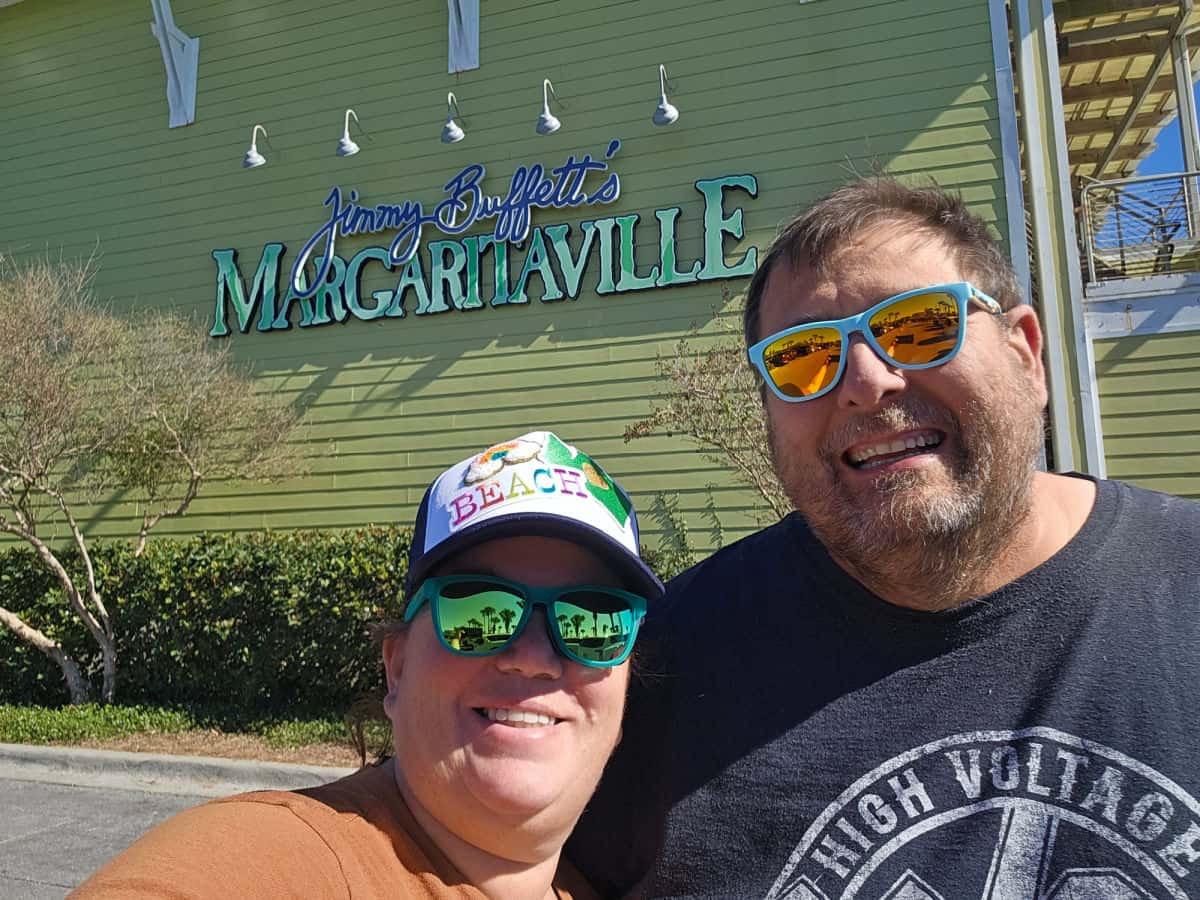 Tammilee and John standing in front of Margaritaville Restaurant Panama City Beach