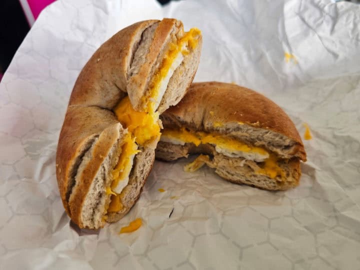 egg and cheese bagel on white paper