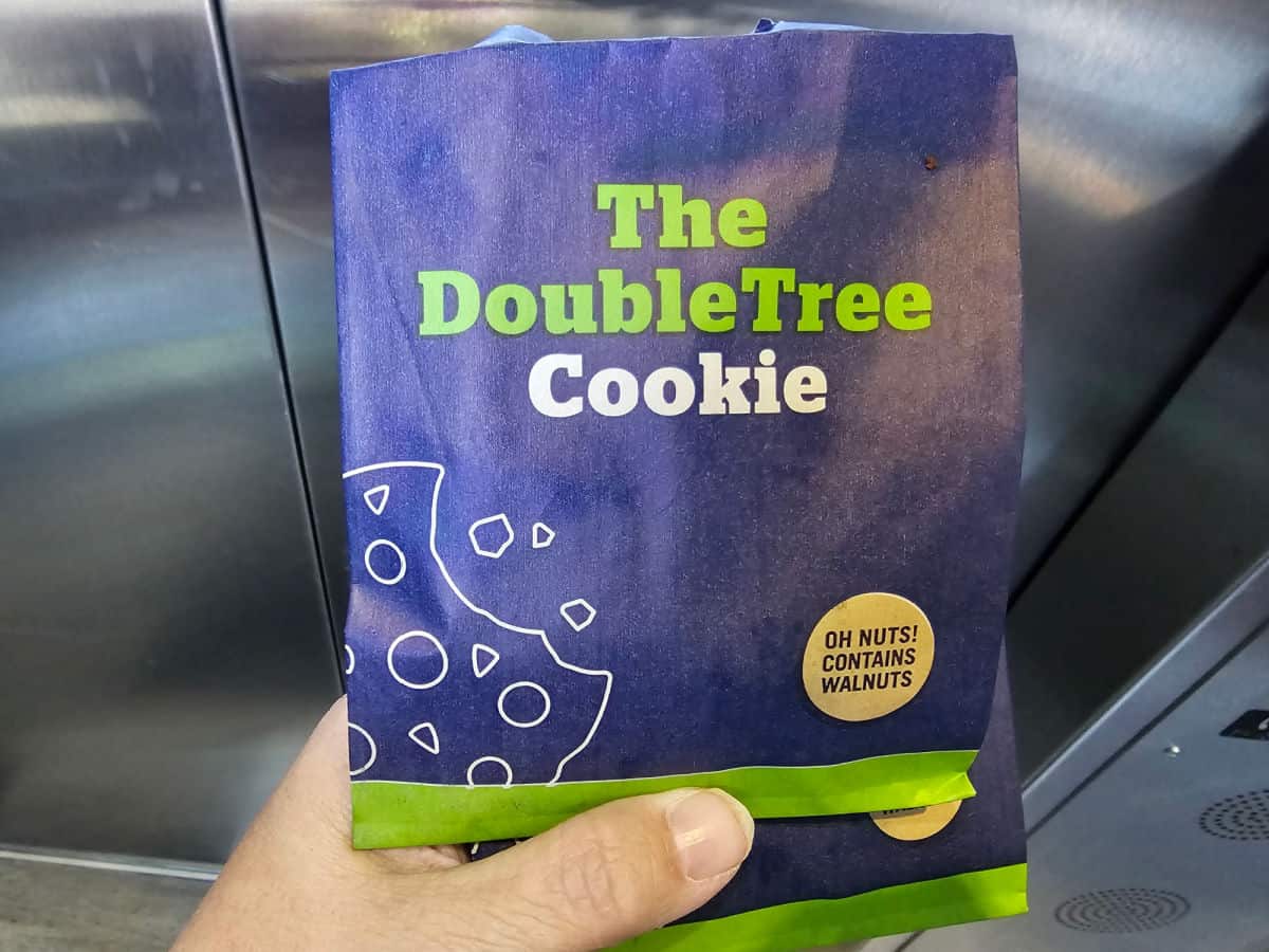 The DoubleTree Cookie bag held by a hand in an elevator