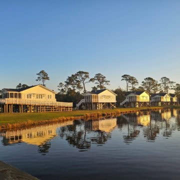 Lakeside Cabins in a row with the reflection on the waters of Lake Shelby