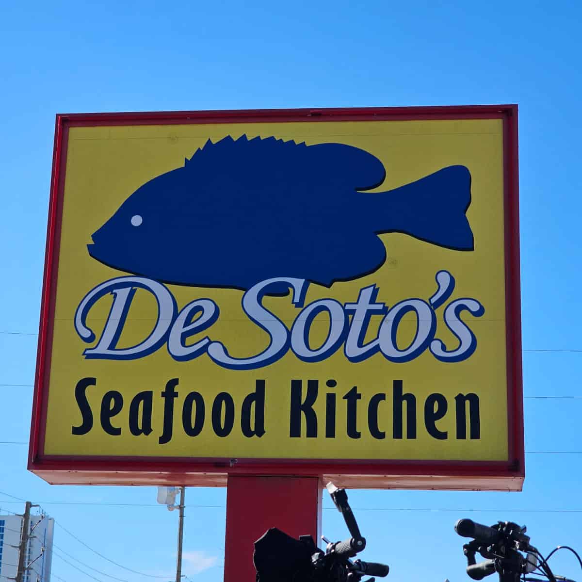 DeSoto's Seafood Kitchen Sign with blue fish on a yellow background
