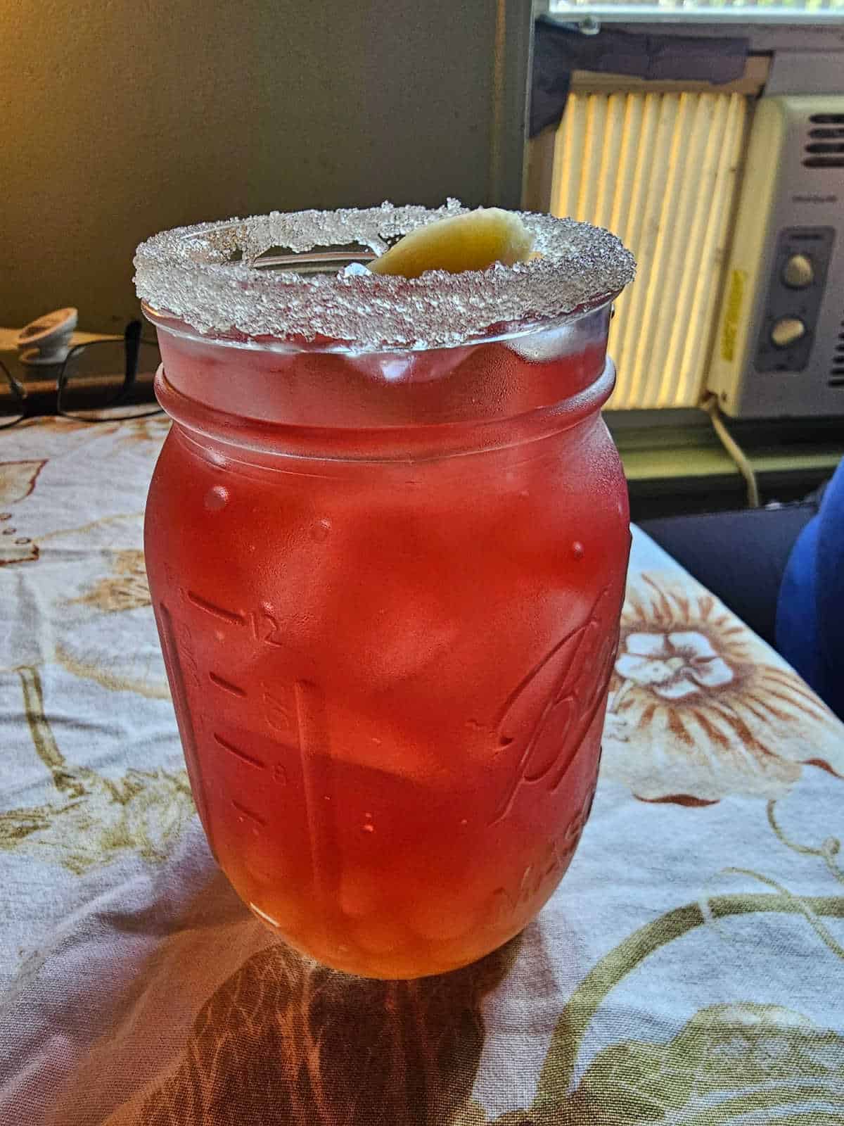 pink tea in a mason jar with a sugared rim