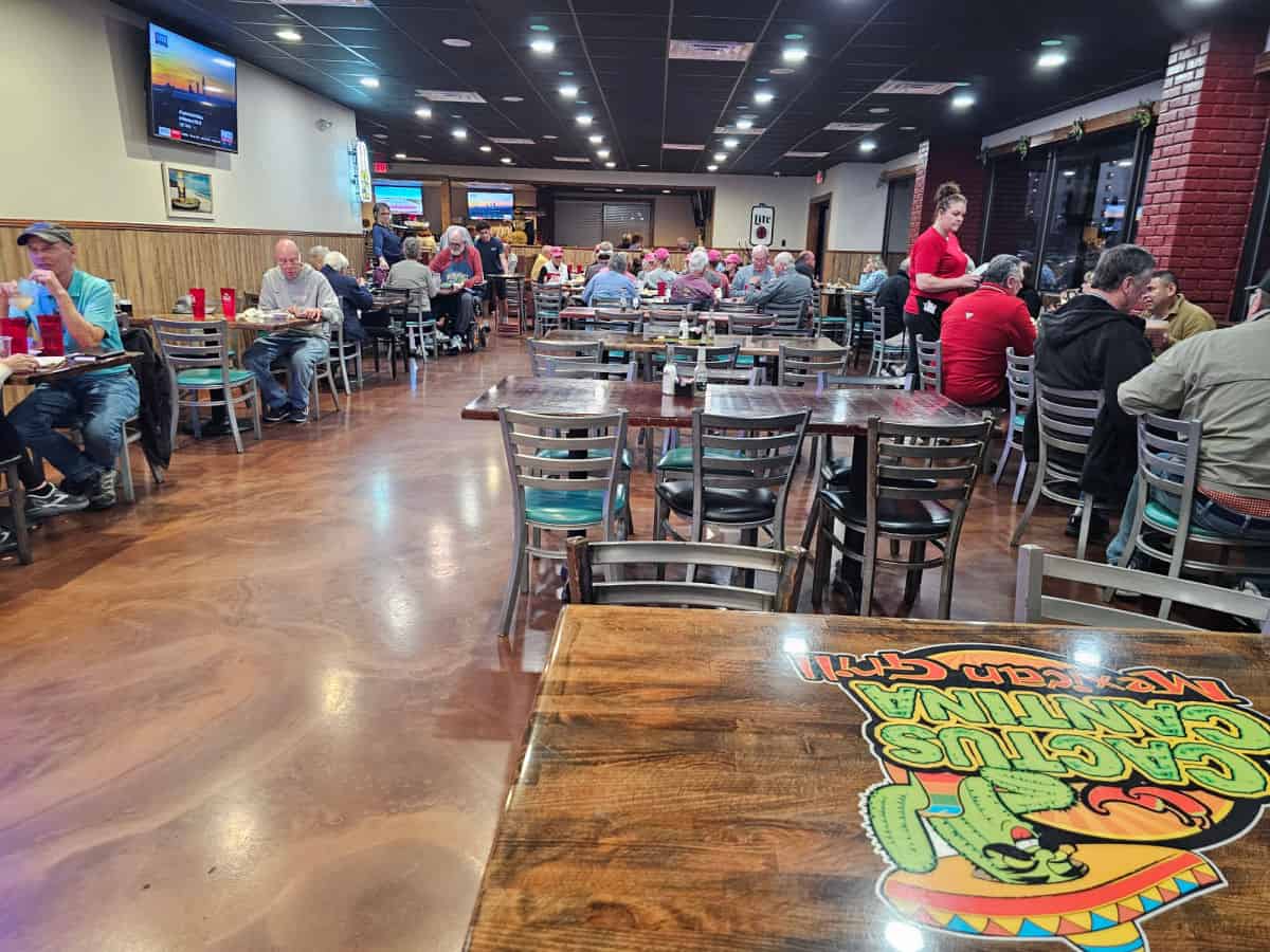 indoor seating with tables and chairs, Cactus cantina logo on a table