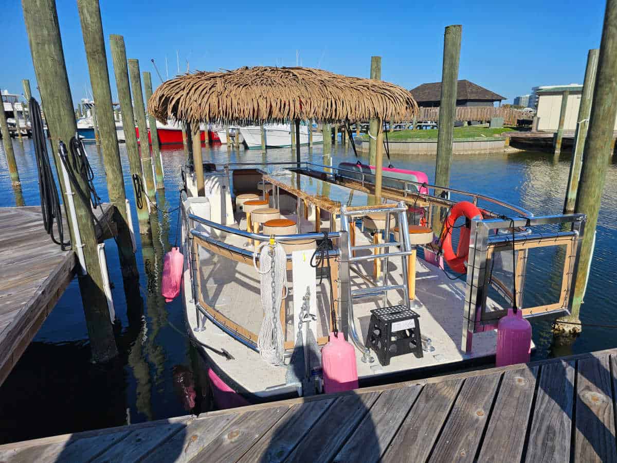 Looking into the Pink Pearl Tiki Boat with bar, stools, and seating