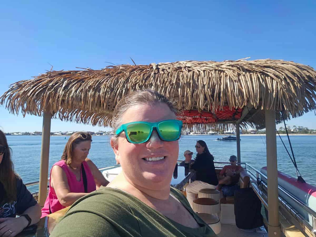 Tammilee on tiki boat with people lounging
