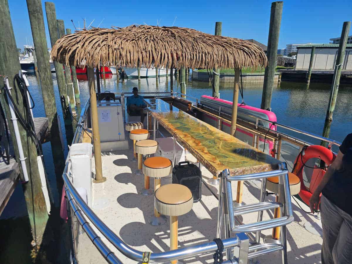 bar with stools, tiki thatch cover over seating area on a boat
