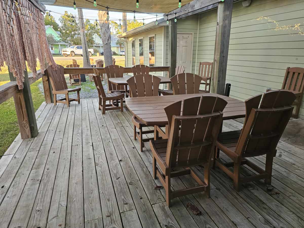 outdoor seating with tables and chairs under a cover