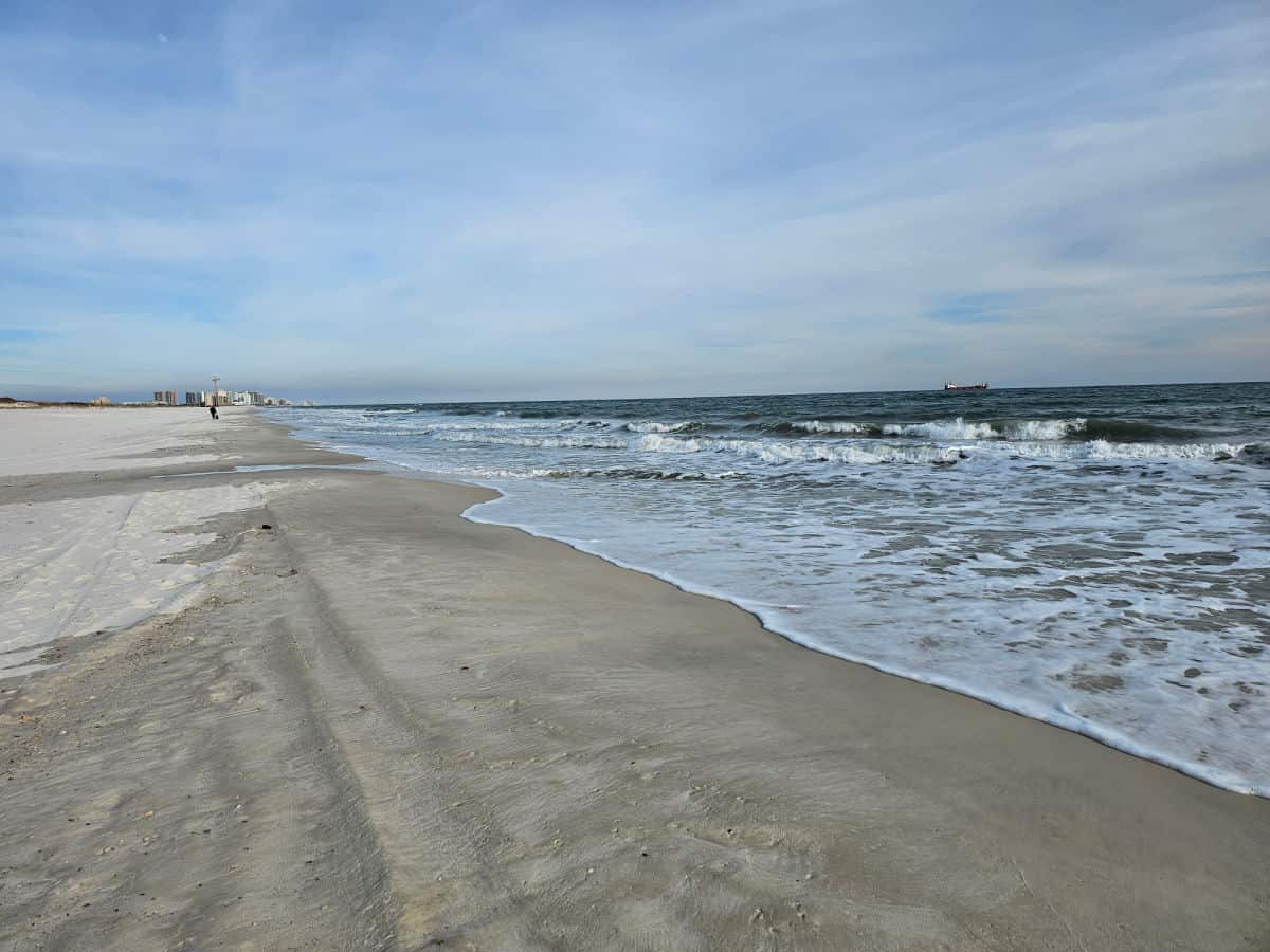 shoreline with white sand, small waves on the Gulf