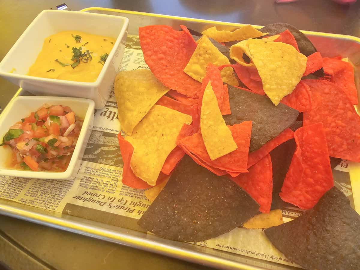 chips and salsa on a paper lined metal tray