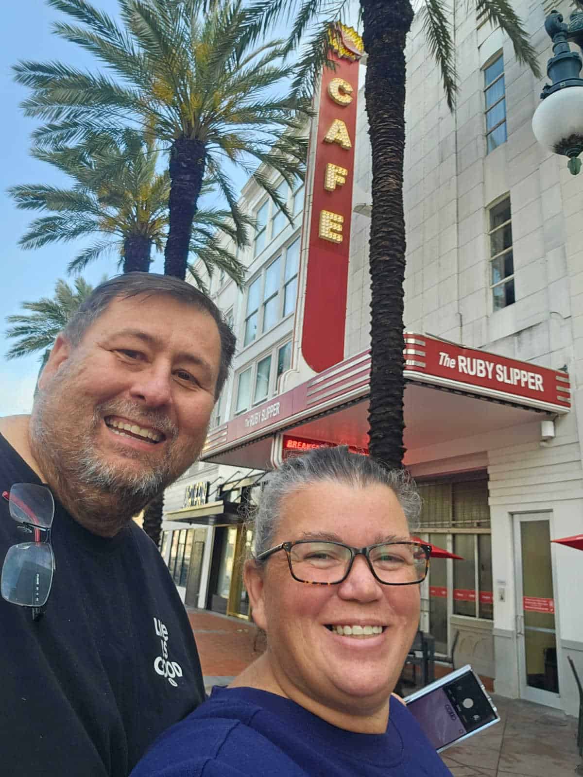 John and Tammilee in front of the Ruby Slipper Cafe marquis sign