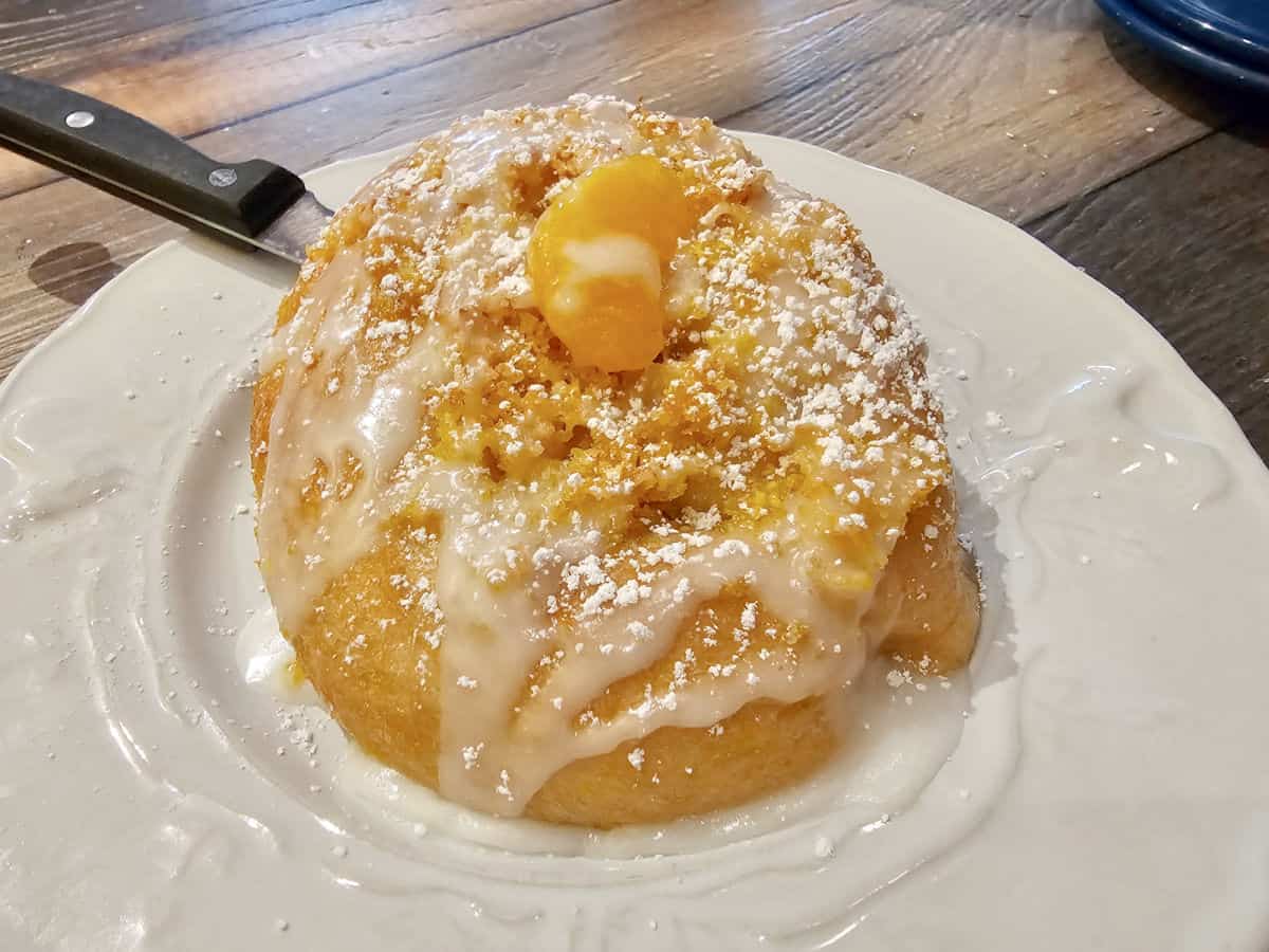 Orange cinnamon roll on a white plate