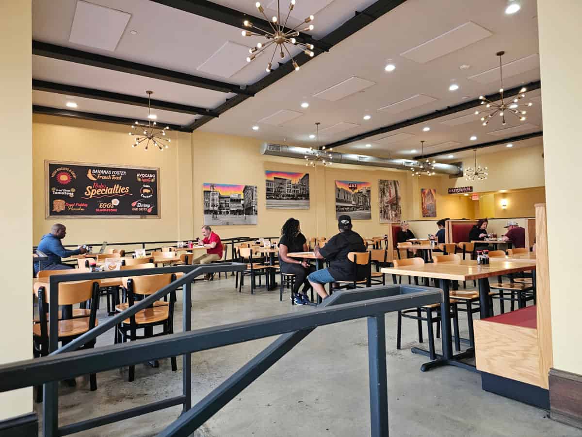 indoor seating with tables and chairs, fun lights hanging from the ceiling, and wall art with Ruby Slipper Specialties