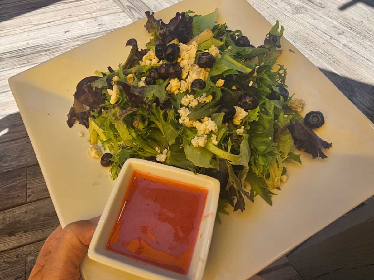 salad with dressing on a white plate