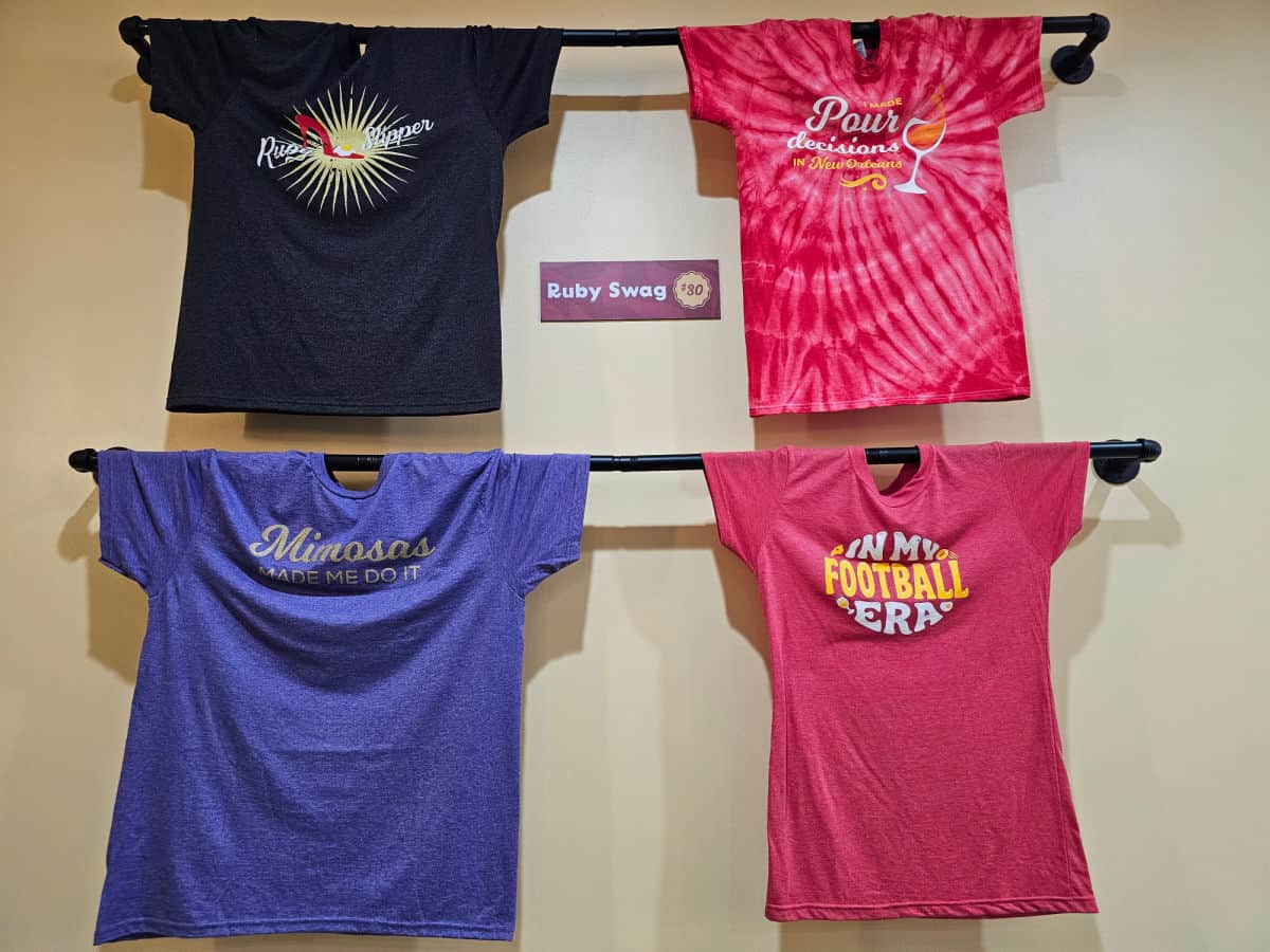 colorful Ruby Slipper t-shirts hanging on the wall