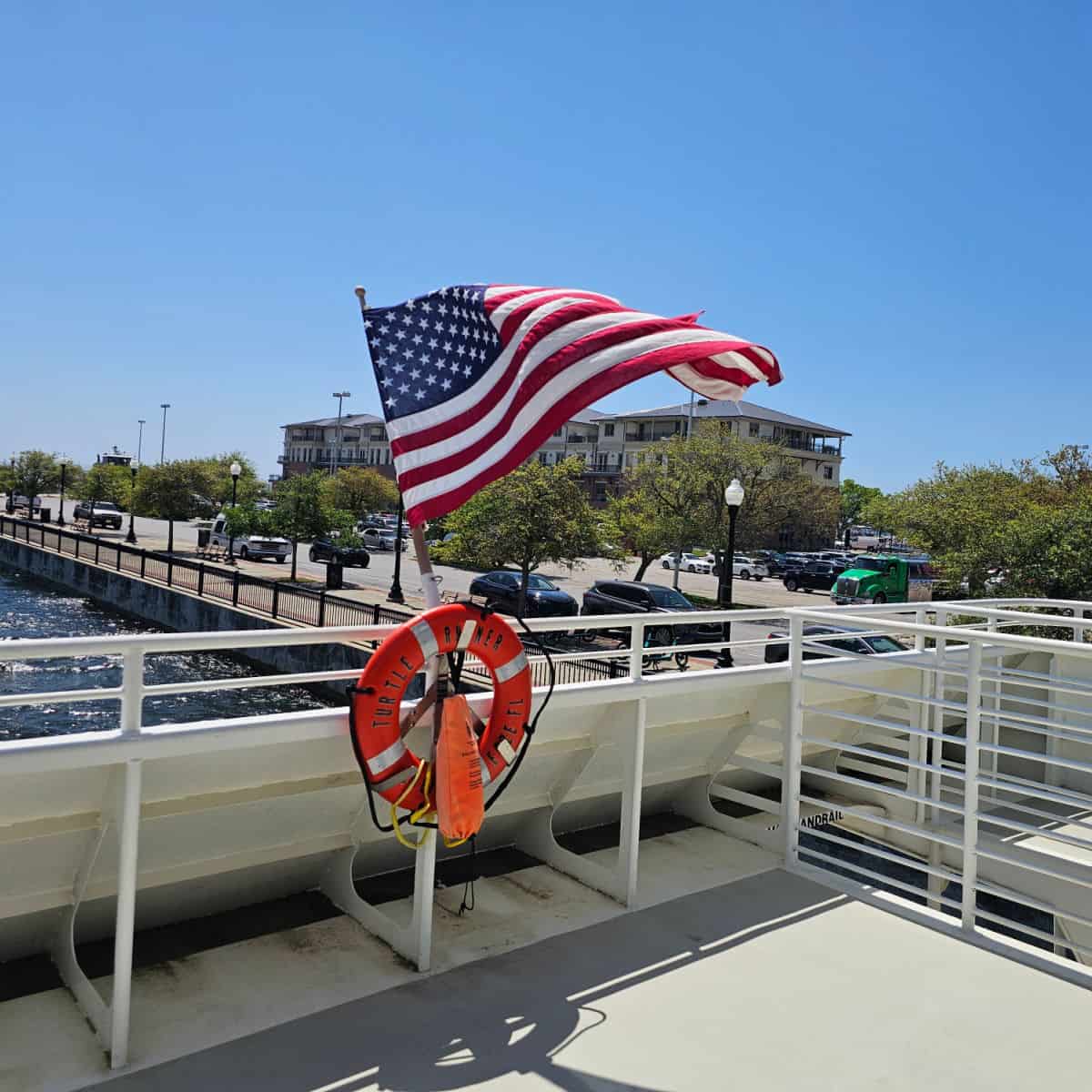 Flag in the wind on the back deck of the pensacola ferry