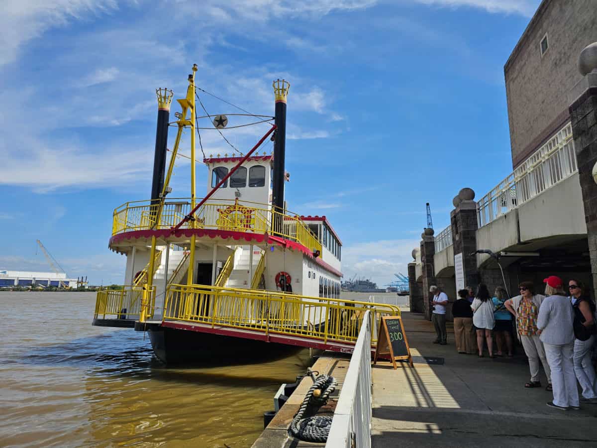 perdido queen boat at dock with people lined up to board