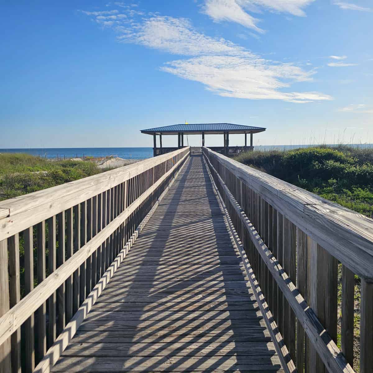 Long boardwalk with a pavilion at the end and the Gulf of Mexico