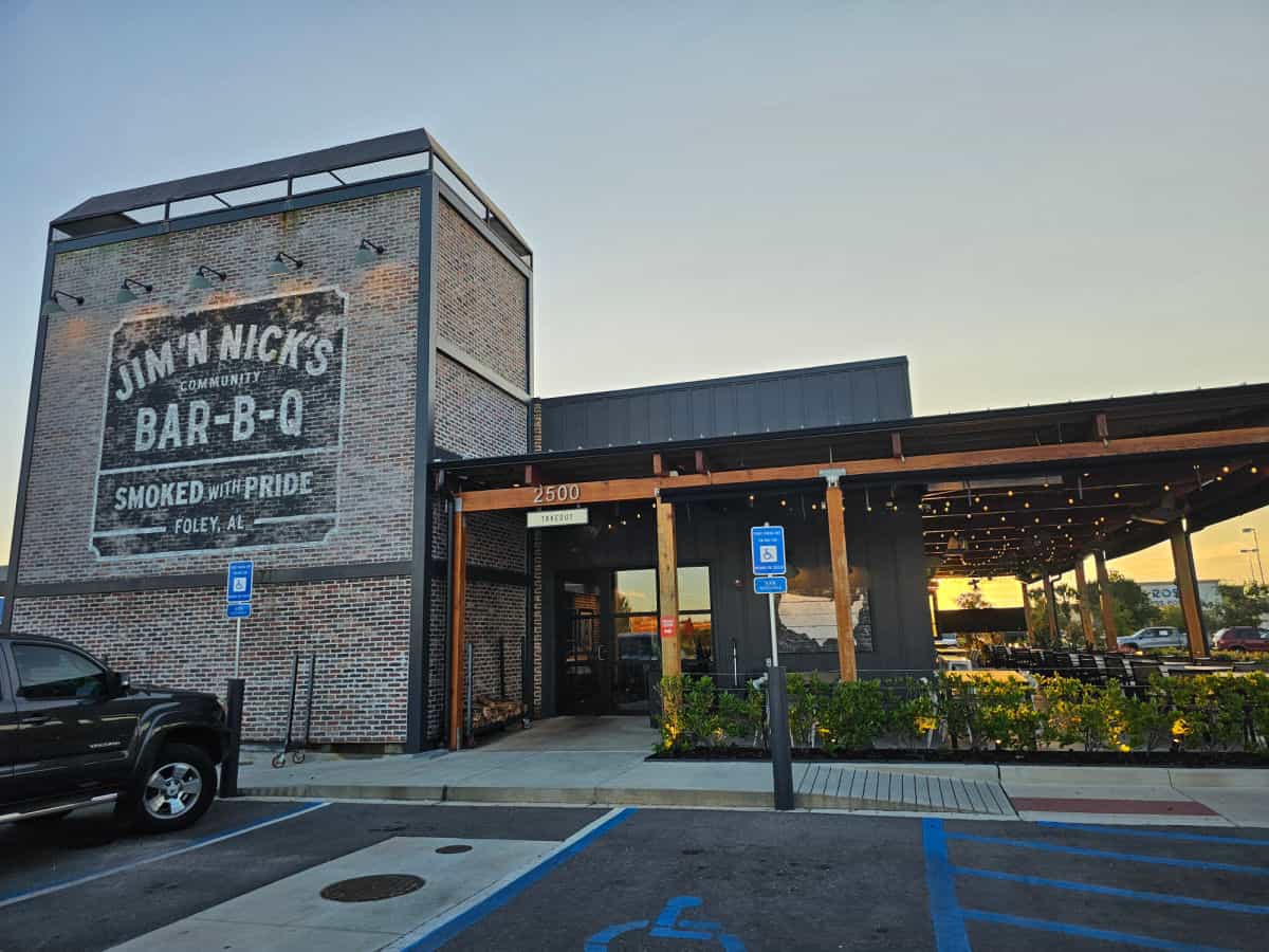 Jim N Nicks BBQ Restaurant Foley exterior with brick wall and outdoor seating